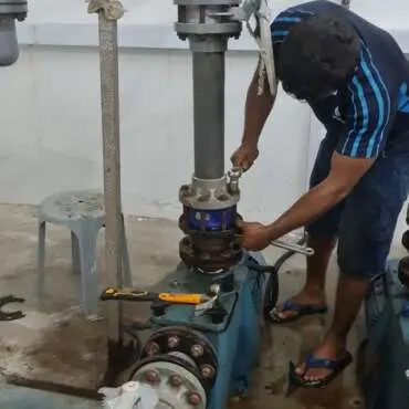 Technician replacing a valve on pool pipework