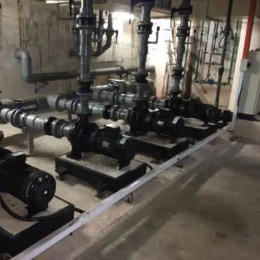 Circulation pumps and pipework in a serviced pump room