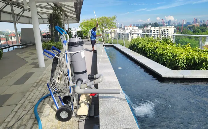 Pool-cleaning equipment beside a pool