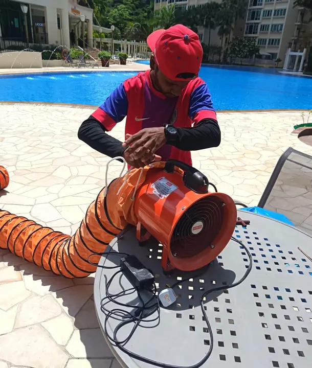 Technician preparing an air blower for cleaning work