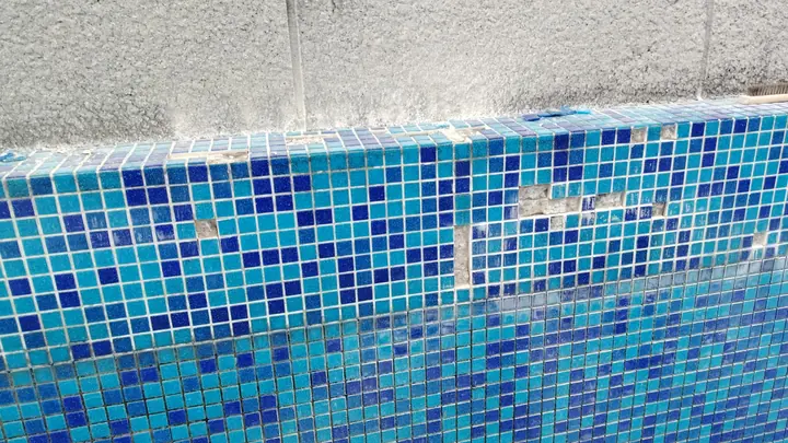 Close view of repaired blue mosaic pool tiles