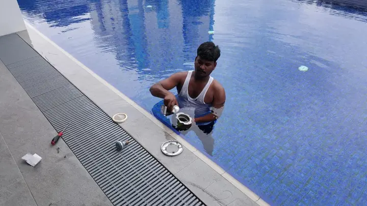 Technician handling pool lights