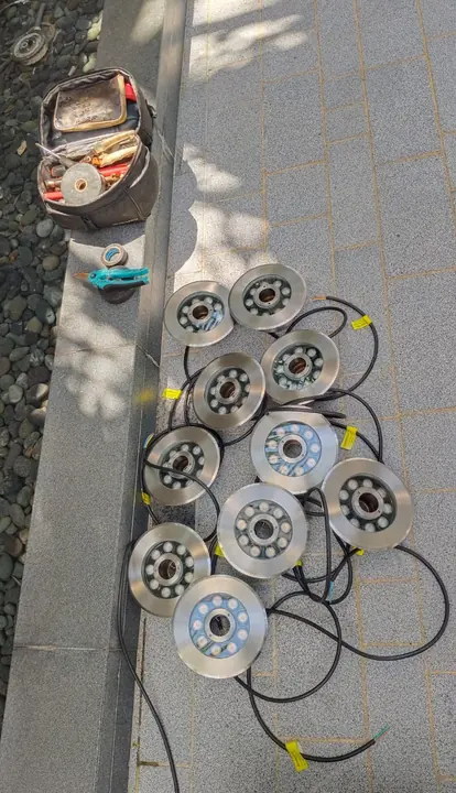 Multiple pool-light fittings and cables prepared outdoors