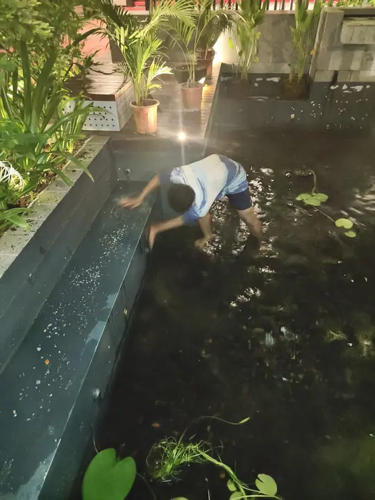 Technician checking a submerged decorative water light