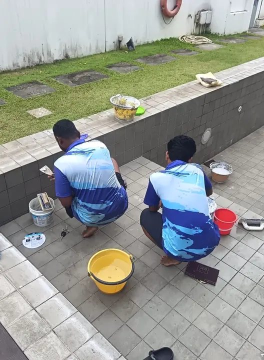 Two technicians carrying out pool wall repairs