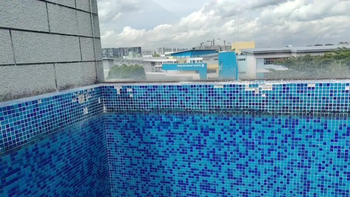 Completed blue mosaic pool wall tiling
