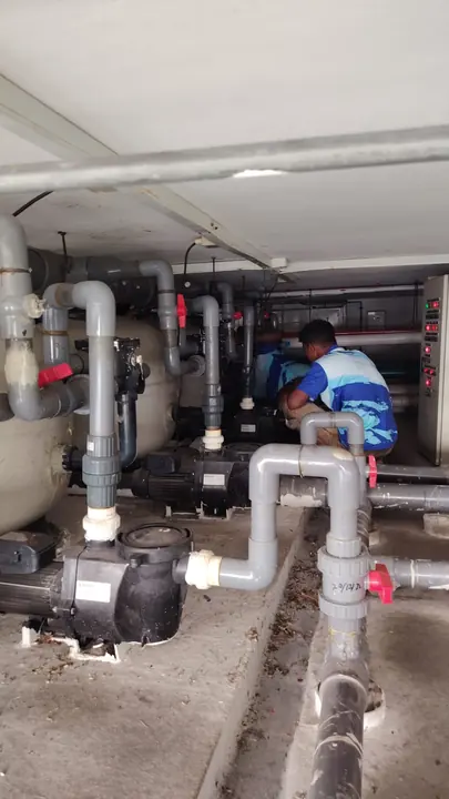 Technician inspecting a pool pump room