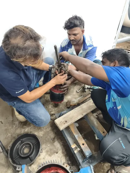 Team repairing a dismantled pool pump motor