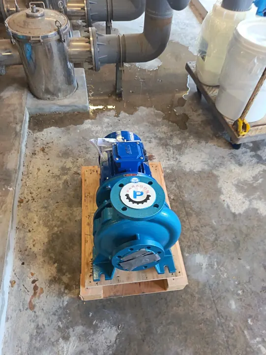 Replacement blue pool pump prepared for installation