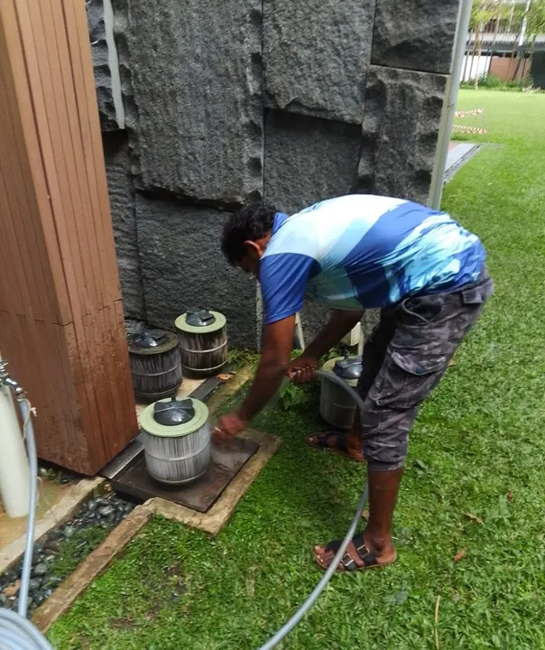 Technician servicing outdoor pool equipment