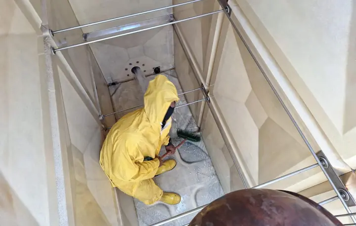 Technician cleaning inside a water tank