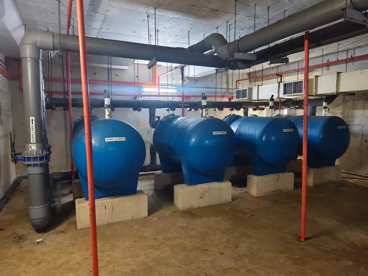 Blue pressure vessels and pipework in a plant room